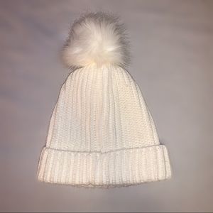 white beanie with a poof